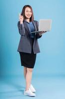 Asian businesswoman on blue background photo