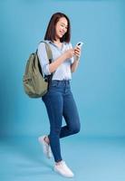 Young Asian student on blue background photo