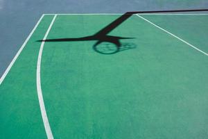 shadows on the green street basket court, green background photo