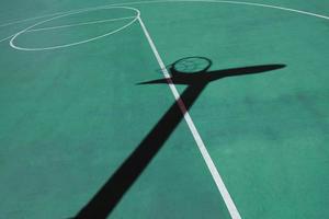 shadows on the green street basket court, green background photo