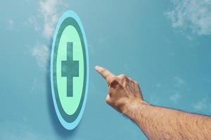 hand pointing at pharmacy icon, health insurance photo