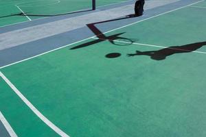 shadows on the green street basket court, green background photo