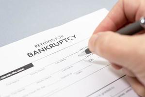 Hand filling a Bankruptcy form photo