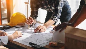 Confident team of architect working together in a office.Then discussing about new startup project on desk.in office photo