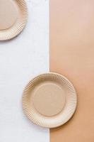 The concept of eco-friendly utensils for food. A cardboard plate on a two-tone background. Top  and vertical view. photo