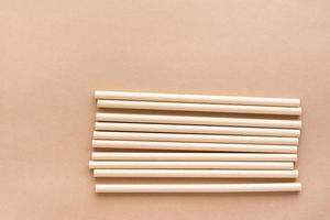 Cardboard drinking straws on a beige background. Eco friendly and zero waste concept. Top view. photo
