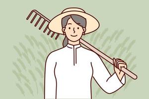 Farmer woman holding rake on shoulder after completing soil preparation for planting crops. Girl farmer in straw hat works in agricultural industry doing manual labor harvesting organic food vector