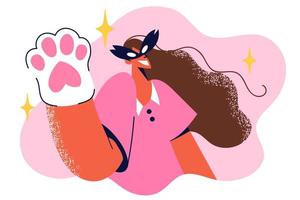 Teenage girl in cat mask waves kitten glove to say hello to participants of children party or Halloween masquerade. Schoolgirl came to party in casual clothes and cats paw on hand vector