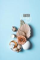 Happy Easter text with easter eggs and flowers composition. Easter vertical greeting card photo