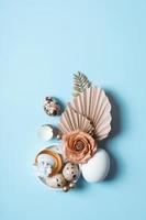 Modern creative composition with easter eggs, palm leaves and flowers top view. Easter flat lay photo
