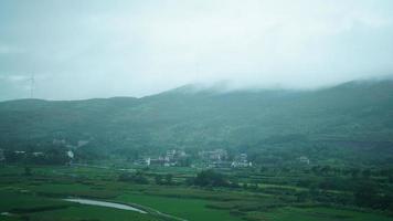 The beautiful countryside view from the runny train on the south of the China in the rainy day photo