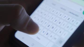 Typing a message from the close-up phone keyboard. Close-up of the message typed on the phone's keyboard. video