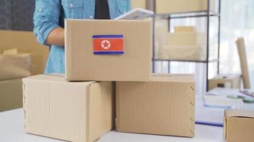 North Korea flag on logistics cargo package. Cargo package with flag of North Korea. video