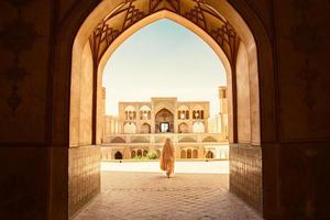 Kashan, Iran, 2022 - Tourists and pilgrims explore sightseeing beautiful Agha Bozorg Mosque photo