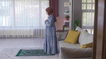 Happy young muslim woman praying in islamic faith. Believer Muslim Woman praying at home. video