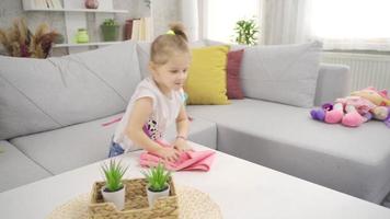 The cute little girl helps her mother with the cleaning. Hyperactive daughter helping her mother at home. video