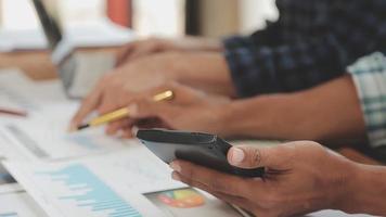 Financial analysts analyze business financial reports on a digital tablet planning investment project during a discussion at a meeting of corporate showing the results of their successful teamwork. video