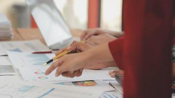 Financial analysts analyze business financial reports on a digital tablet planning investment project during a discussion at a meeting of corporate showing the results of their successful teamwork. video