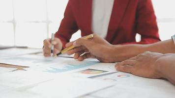 Financial analysts analyze business financial reports on a digital tablet planning investment project during a discussion at a meeting of corporate showing the results of their successful teamwork. video