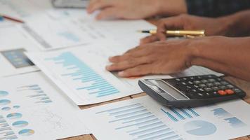 Financial analysts analyze business financial reports on a digital tablet planning investment project during a discussion at a meeting of corporate showing the results of their successful teamwork. video