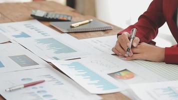 Financial analysts analyze business financial reports on a digital tablet planning investment project during a discussion at a meeting of corporate showing the results of their successful teamwork. video