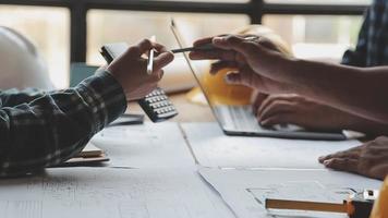 Construction and structure concept of Engineer or architect meeting for project working with partner and engineering tools on model building and blueprint in working site, contract for both companies. video