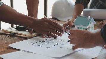 Construction and structure concept of Engineer or architect meeting for project working with partner and engineering tools on model building and blueprint in working site, contract for both companies. video