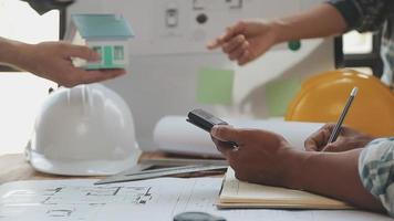 Construction and structure concept of Engineer or architect meeting for project working with partner and engineering tools on model building and blueprint in working site, contract for both companies. video