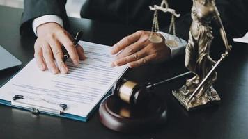 Male lawyer working with contract papers and wooden gavel on tabel in courtroom. justice and law ,attorney, court judge, concept. video