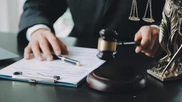 Male lawyer working with contract papers and wooden gavel on tabel in courtroom. justice and law ,attorney, court judge, concept. video