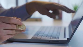 Financial investment. Bitcoin in businessman's hand. Male hand spinning glowing yellow bitcoin in hand. video