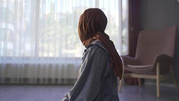feliz jovem muçulmano mulher Rezar dentro islâmico fé. crente muçulmano mulher Rezar às lar. video