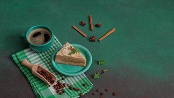 Fresh delicious Cake Napoleon with cream on a green background. A cup of hot coffee, cinnamon stick, badyan, coffee beans on a green background. Copy space video