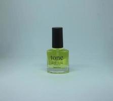 Central Jakarta, Indonesia - March 12th, 2023 - Tone nail vitamin with keratin and calcium. Safe to use daily nail product. Vitamin kuku tone with kalsium in compact glass nail polish bottle shape. photo
