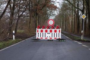 Closed road with a roadblock and traffic signs photo