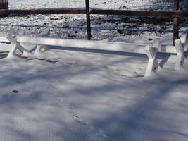 White obstacle bars - cavaletti covered with snow photo