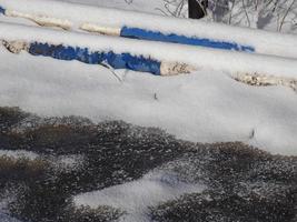 Blue and white obstacle bars covered with snow photo