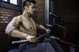 Portrait of asian man big muscle at the gym,Thailand people,Workout for good healthy,Body weight training,Fitness at the gym concept photo