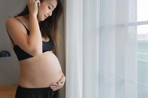 Portrait of asian pregnant woman in the bedroom photo