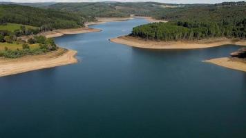 Tranquil Waters Reservoir With Dense Forest. Aerial video