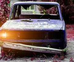 Disassembled abandoned car photo