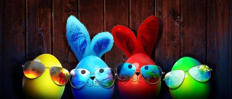 Easter background with colorful easter eggs on wooden background. photo