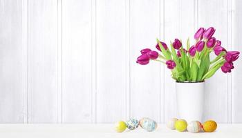 Beautiful Easter background with colorful tulips and easter eggs. photo