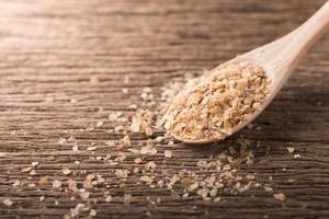 Wheat germ on wood spoon photo