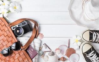 prepare accessories and travel items on white wooden background photo