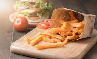 french fries on wood block and dark wood background photo