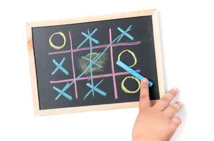 boy  hand drawing a game of tic tac toe photo