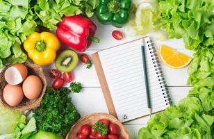 Fresh vegetables and fruit on wood background, healthy food photo