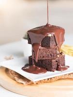 pour chocolate to brownie cake photo
