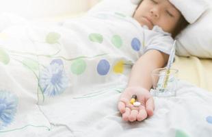 pill in little girl hand photo